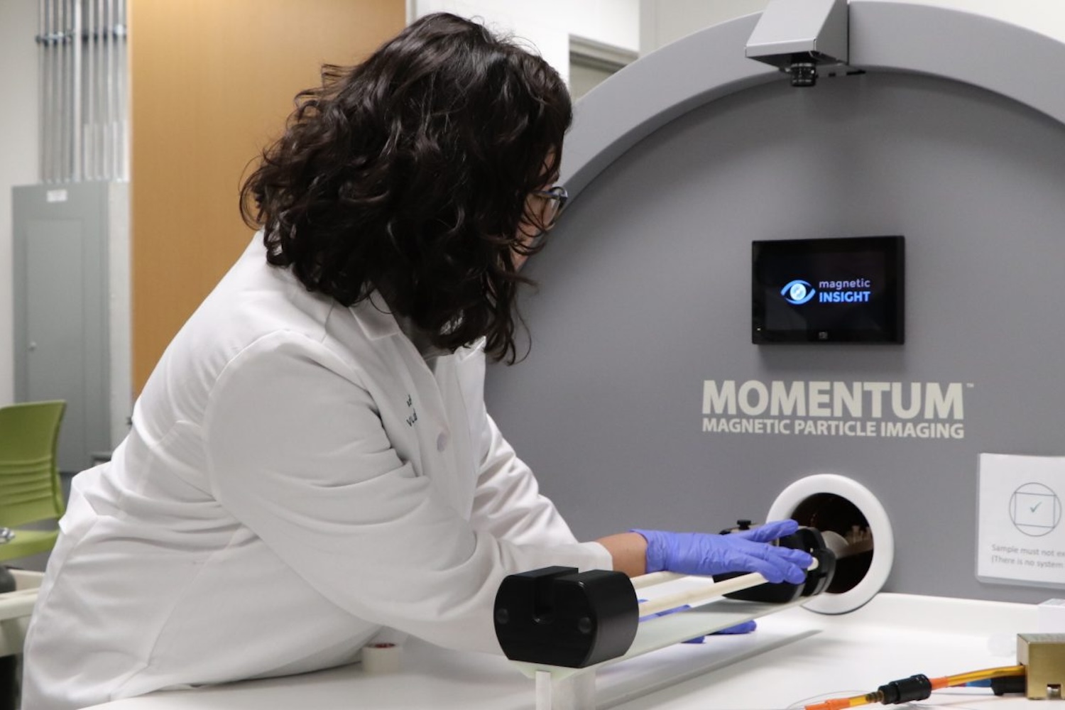 Researcher using a Momemtum Magnetic Particle Imaging instrument